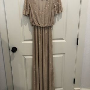 Beaded. Never altered. I’m a size 4 & 5’6 and wear a small. XS fit perfectly.